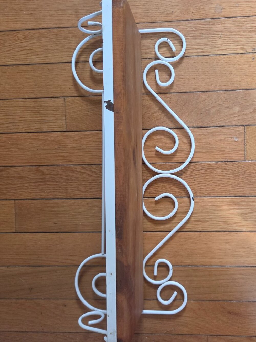 white rustic metal and wood shelf with ornate scrollwork